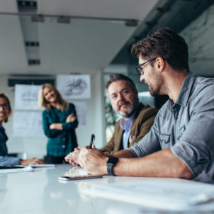 Businessman sharing ideas on project to team